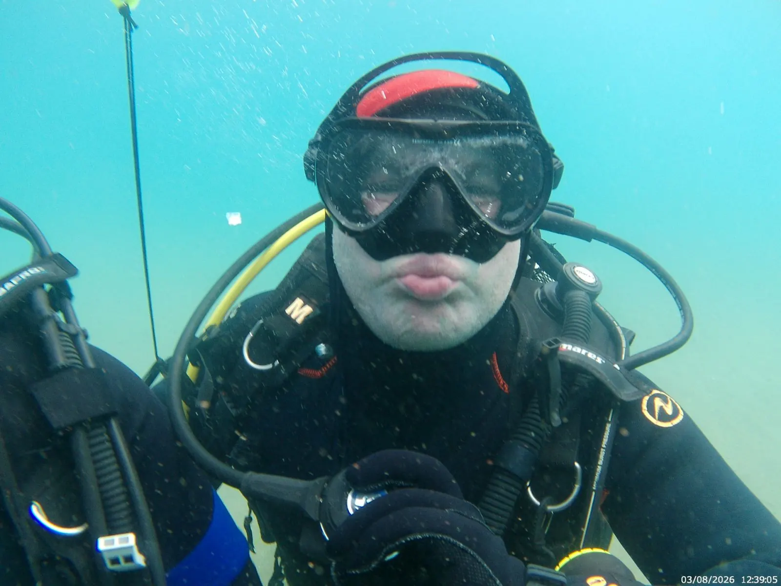 Underwater view of a fully equipped scuba diver cleaning the lakebed of Lake Ohrid