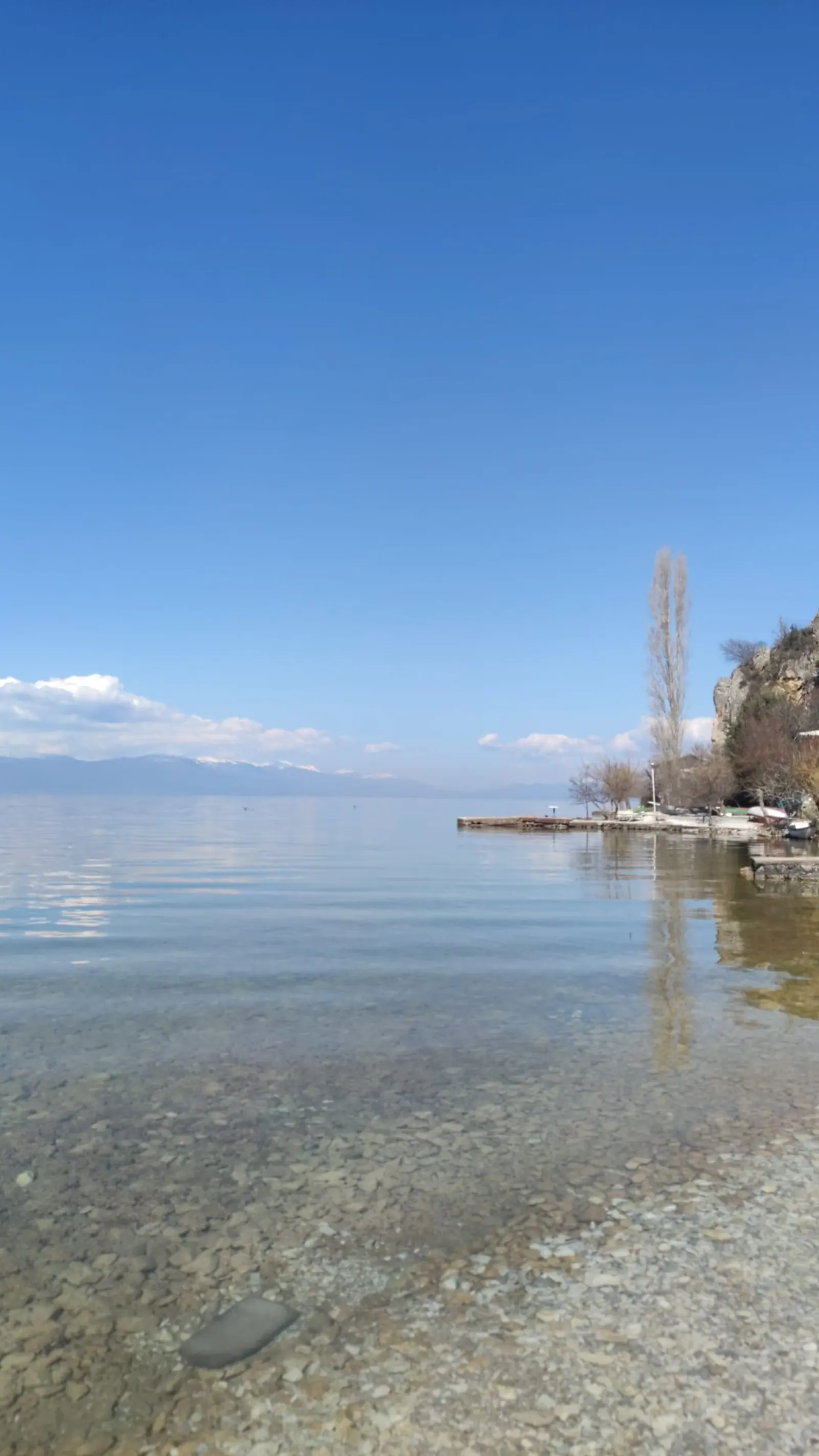 Clear water and pebbled shore at Kaj Divono beach — the location of the cleanup action on Lake Ohrid