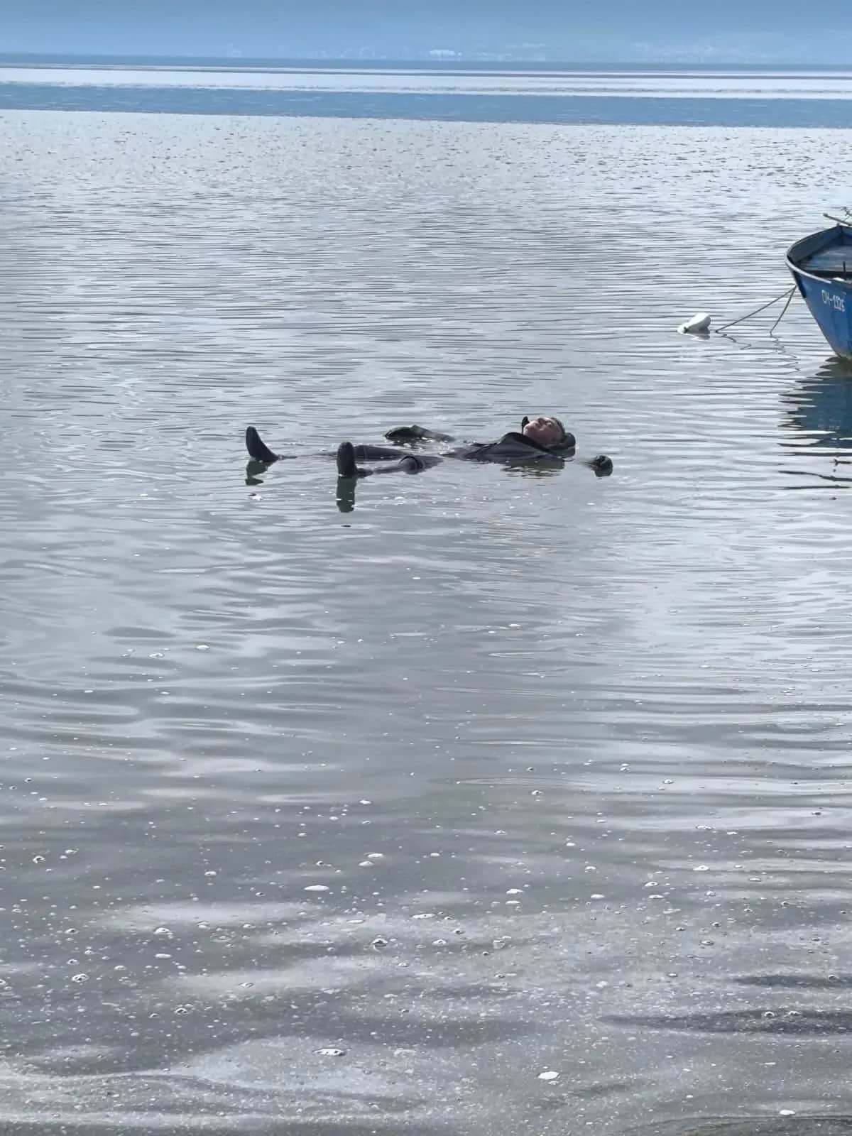 Amphibia team member floating relaxed on his back in Lake Ohrid after the dive